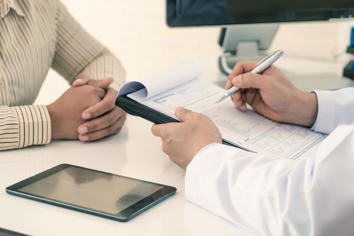 A pharmacist discusses options with a patient.